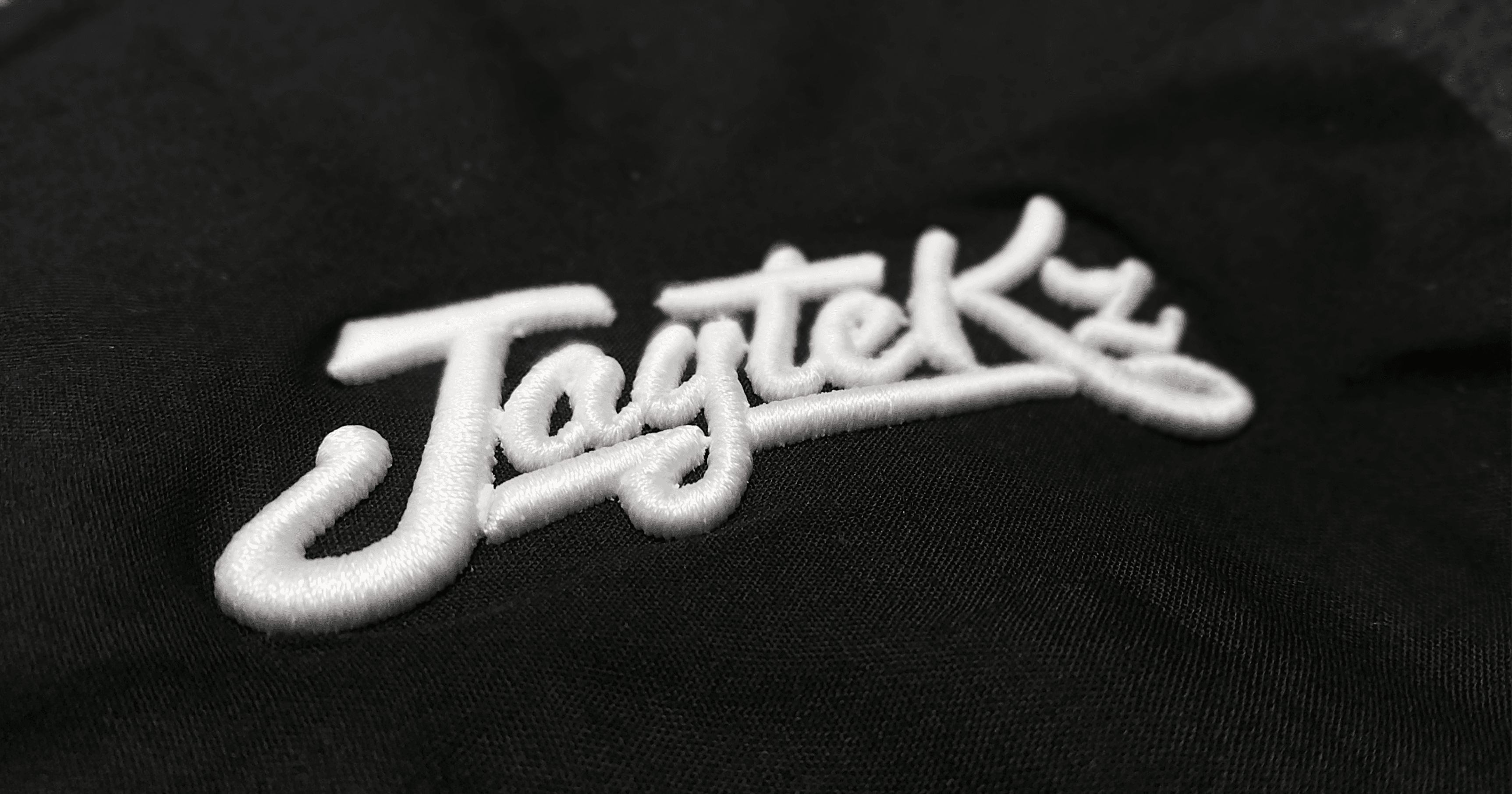Extreme close-up of raised puff embroidery showcasing foam elevation and premium thread depth
