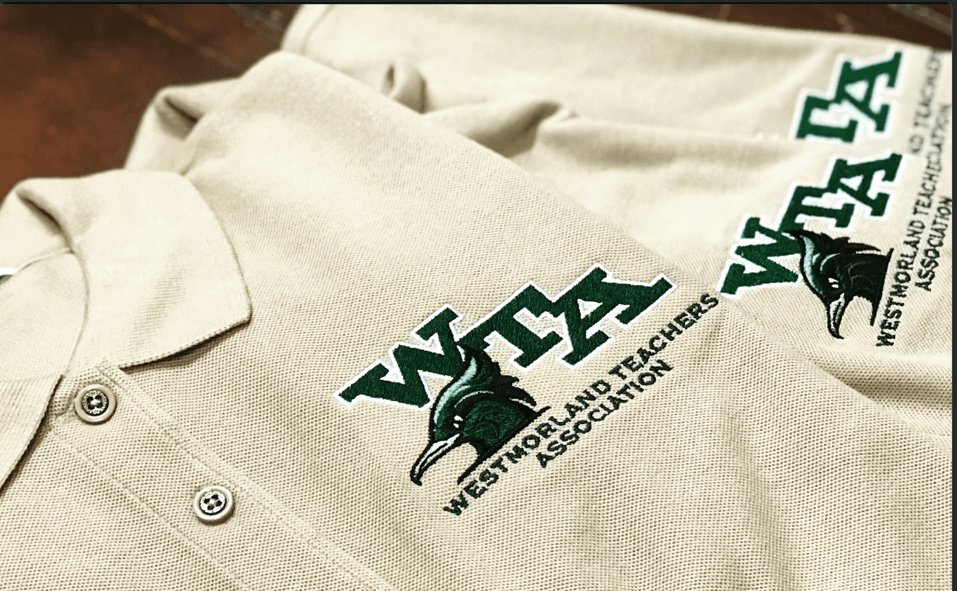 Premium embroidered polos and apparel showcasing production-grade branding applications