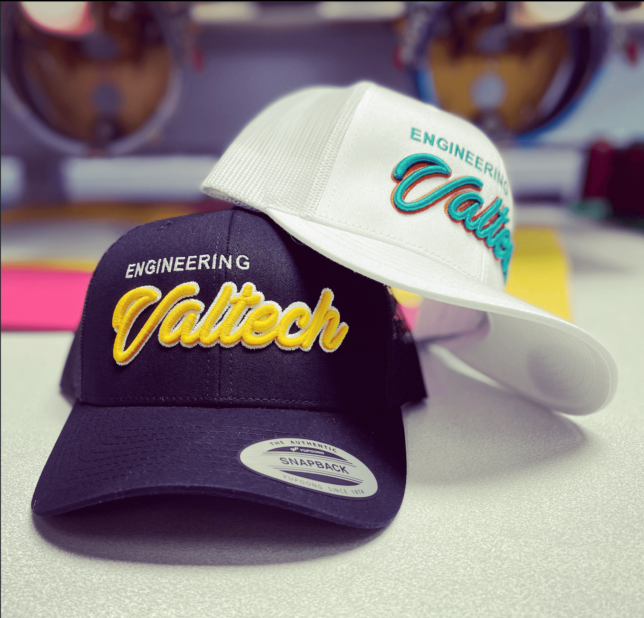 Premium embroidered custom hats with bold multi-color stitching and commercial production quality