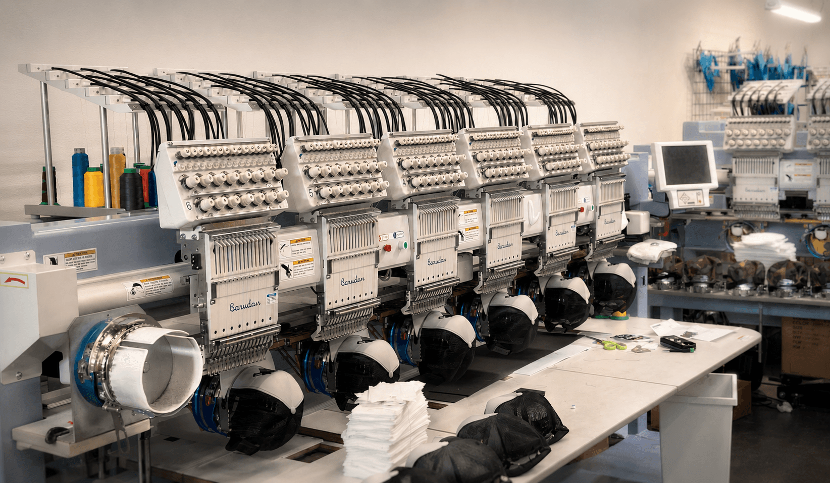 Commercial multi-head embroidery machine actively running production orders